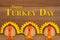 Happy Turkey Day sign with turkeys on wood