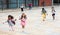 Happy tween schoolchildren with backpacks running to school outdoors