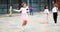 Happy tweenager girl skipping rope in schoolyard