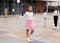 Happy tweenager girl skipping rope in schoolyard