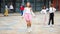 Happy tweenager girl skipping rope in schoolyard