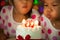 Happy twin two asian little girls celebrating birthday