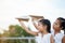 Happy two asian child girls playing with toy paper airplane