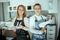 happy two women hairdressers in aprons in beauty salon