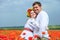 Happy ukrainian couple in blossom poppies field