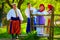 Happy ukrainian family in traditional costumes talking near the wooden fence