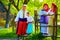 Happy ukrainian family in traditional costumes talking outdoor