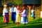Happy ukrainian family in traditional costumes talking outdoor