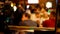 Happy Ukrainian friends eating and drinking in bar or pub at night - defocused