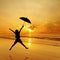 Happy umbrella Woman Jumping in beach and Sea Sunset