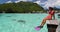 Happy vacation snorkel girl relaxing at overwater bungalow balcony at luxury resort in Moorea, tahiti. Snorkeling sport