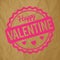 Happy Valentine rubber stamp pink on a crumpled paper brown background.
