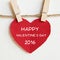Happy valentine\'s day on red fabric heart shape hanging on cloth