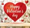 Happy Valentine`s day in red heart floating above wood table at