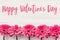 Happy Valentine`s Day text sign on pink gerbera on white wooden background, flat lay. Valentines day floral greeting card