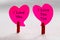 Happy Valentine`s Day.  Two Hearts standing on clips that make a mutual declaration of love