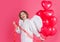 Happy Valentines day. Angel woman with red heart shape balloons. Smiling female cupid with wings.