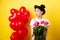 Happy Valentines day. Sad and lonely girl looking left upset, holding bouquet of roses, standing alone near red hearts