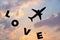 Happy Valentines Day, silhouette plane fly at twilight sunset sky with word love