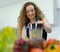 happy vegetarian woman smile, cooking healthy fruit juice in blender in kitchen with copy space. beautiful caucasian woman cooking