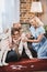 happy vintage family hugging while playing dominoes