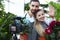 Happy Vlogger Holding Domestic Flowers in Pot