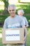 Happy volunteer senior holding donation box