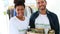 Happy volunteer team holding a food donation box