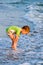 Happy walking child on the sea