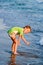 Happy walking child on the sea