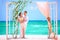 Happy wedding couple on decorated tropical beach