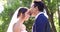 Happy wedding, couple and kiss in park, nature or support of celebration, bridal union or marriage people. Bride, groom
