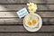 Happy weekend greeting card with fried egg and flower on wood background