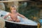 Happy well-tanned child boy in the boat