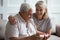 Happy wife greeting senior husband with birthday