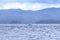 Happy wild pantropical spotted dolphin, Stenella attenuata, jumps free near a whale watching boat in the middle of the Pacific