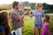 Happy wine grower family walking in vineyard