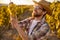 Happy winemaker examining ripe grapes