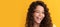 happy winking teen girl with long curly hair and perfect skin, frizzy. Child face, horizontal poster, teenager girl