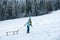 Happy winter child sledding in winter snowy forest. Kids with sled, sleigh in snow. Little boy enjoy the holiday.