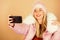 Happy winter holidays. web blogger. girl in puffed coat make selfie. faux fur fashion. warm winter clothing. phone