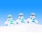 Happy winter snowmen family against blue sky