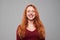 Happy woman with auburn hair looking at the camera