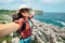 Happy woman backpacker traveler take a selfie photo on amazing o