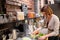 Happy woman or barmaid cooking at vegan cafe