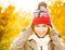 Happy Woman in Beanie Hat on Autumn Background