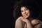 A happy woman is a beautiful woman. Cropped portrait of an attractive young woman posing in studio against a dark