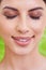 Happy, woman and beauty with makeup, smile and cosmetics with green background. Skincare, wellness and dermatology with