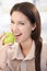 Happy woman biting an apple smiling
