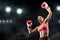 Happy woman boxing champion raising hands up at ring